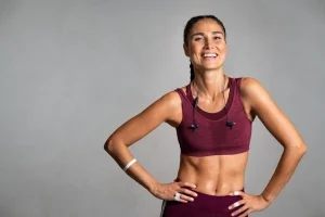 A woman with toned arms displays the results of an arm lift brachioplasty.
