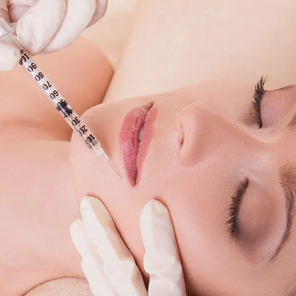 A stunning woman receiving treatment from a surgeon in Singapore for lip wrinkles.